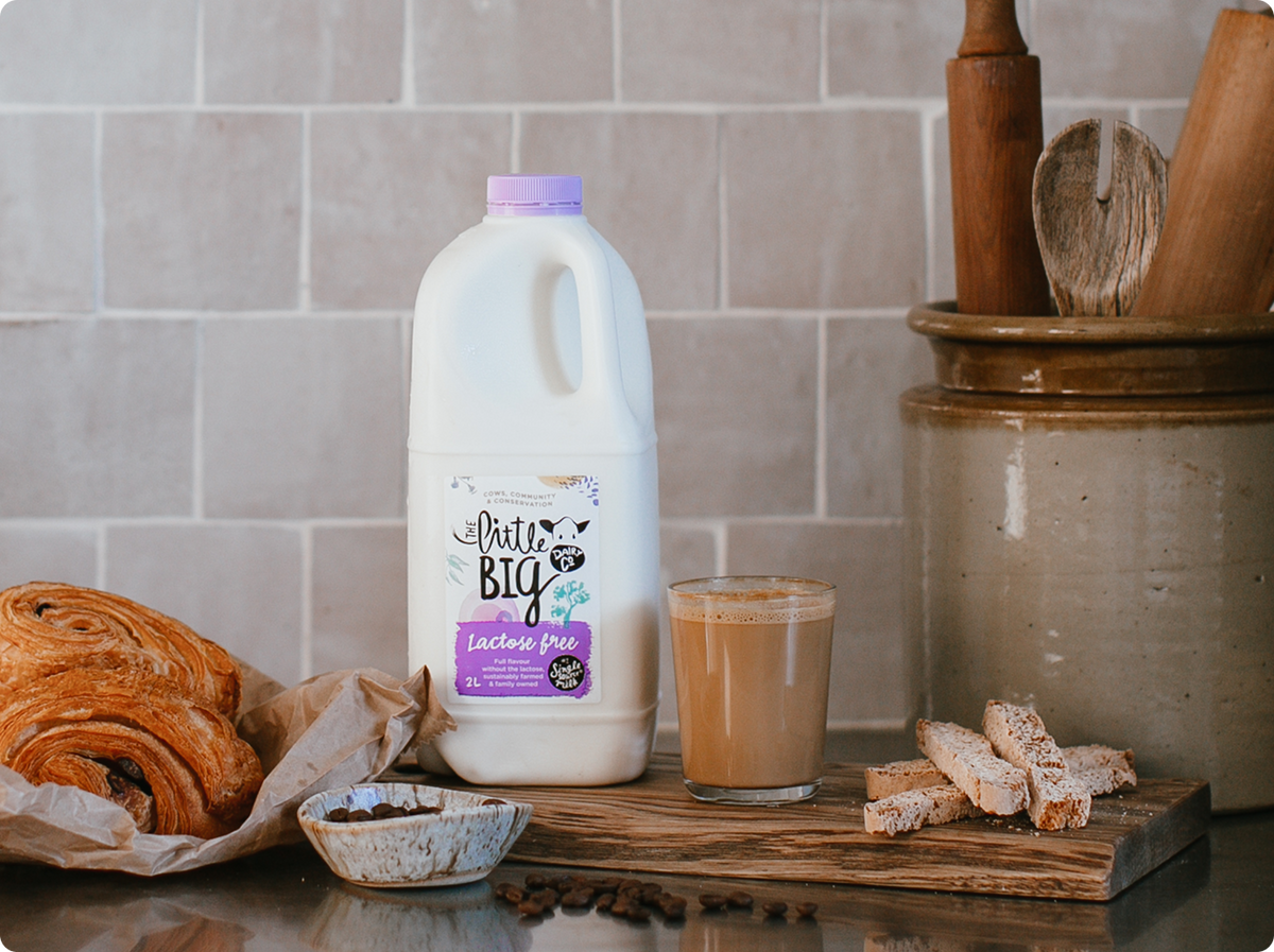 Lactose Free 2L bottle on kitchen bench with pastries